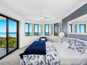 a bedroom with a bed with a view of the ocean at Shoreline 6 with Ocean Views To See The Whales in Hastings Point