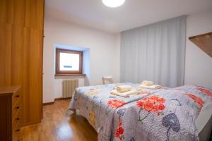 a bedroom with a bed with towels on it at Cozy Apartment In The Heart Of Riva in Riva del Garda
