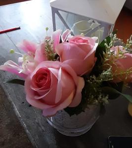 a glass vase filled with pink roses and other flowers at LA CASA Di ALE in Rome