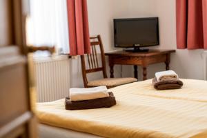 a hotel room with a bed with towels on it at Lafayette in Olomouc