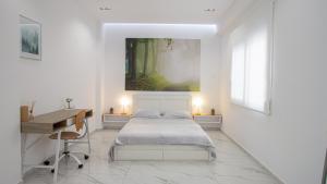 a white bedroom with a bed and a desk at Luxury Apt 115m2 in Athens