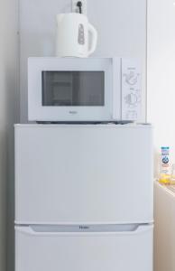 a microwave sitting on top of a refrigerator at japan house edogawabashi in Tokyo