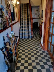 a hallway with a black and white checkered floor at The Eastleigh in Skegness