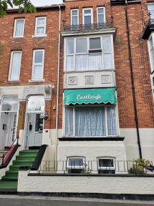 a brick building with a green awning on it at The Eastleigh in Skegness