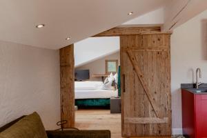 a barn door in a bedroom with a bed at Zur Nandl in St. Wolfgang