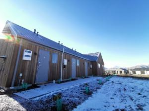 a row of buildings with snow on the ground at Skyrim Lodge in Lake Tekapo