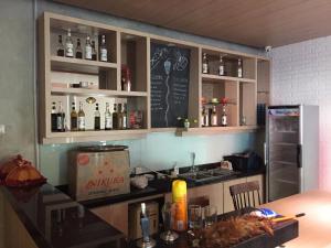 a kitchen with a counter with bottles of alcohol at RedDoorz Plus @ Hotel Alden Makassar in Makassar