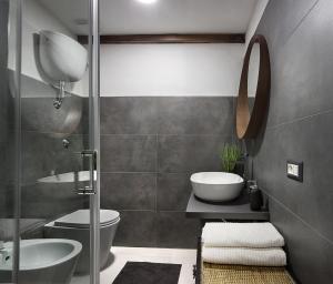 a bathroom with a toilet and a sink and a shower at Host 98 in Cagliari