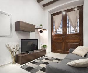 a living room with a couch and a television at Host 98 in Cagliari