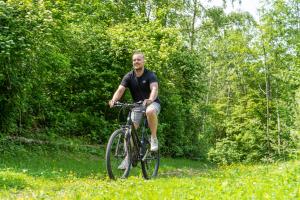 a man riding a bike down a trail at Alpine Hotel by SnowWorld in Landgraaf