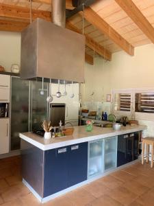 a kitchen with blue cabinets and a counter top at 4 bedrooms villa with private pool enclosed garden and wifi at Camallera in Camallera