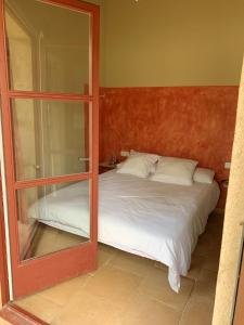 a bedroom with a mirror and a bed at 4 bedrooms villa with private pool enclosed garden and wifi at Camallera in Camallera