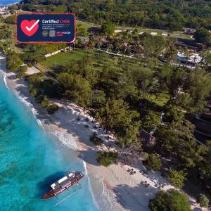 an aerial view of a beach with a boat in the water at Pondok Santi Estate in Gili Trawangan