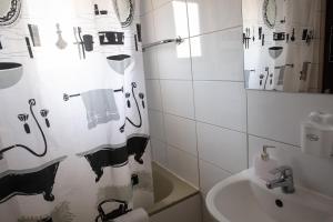 a bathroom with a shower curtain and a sink at Olive Island in Larnaka +37 photos