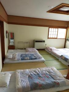 a bedroom with three beds in a room at Suijin Hotel - Vacation STAY 23120v in Chichibu