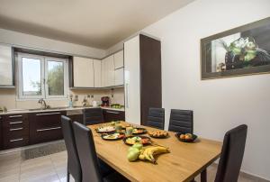 a kitchen with a wooden table with bananas on it at Villa Tranquility in Psinthos