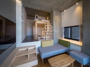 a tiny house with a bench and a window at dots. tokyo in Tokyo