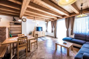 a living room with a table and a blue couch at Obermayrgut in Gallspach