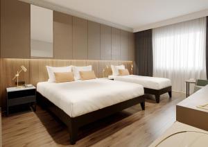 Ένα ή περισσότερα κρεβάτια σε δωμάτιο στο Ring Downtown Hotel