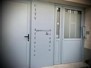 a door with a sign on the side of it at City Affaire : Hotel de Ville in Caen