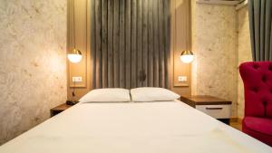Postel nebo postele na pokoji v ubytování DYMAR HOTEL