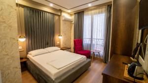 Postel nebo postele na pokoji v ubytování DYMAR HOTEL