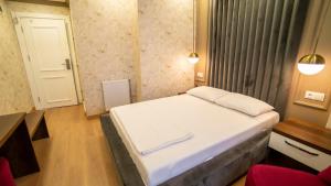 Postel nebo postele na pokoji v ubytování DYMAR HOTEL