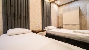 Postel nebo postele na pokoji v ubytování DYMAR HOTEL