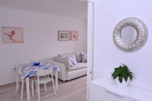 a white living room with a table and a couch at A1 - luxury apt in center just 5min from beach in Korčula