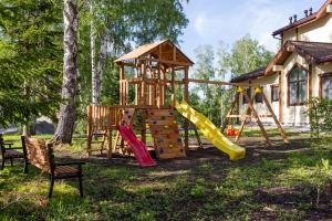 a playground with a slide and a play structure at Гостиница Олимп-парк in Belokurikha