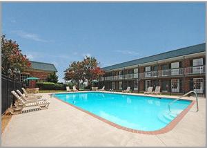 a large swimming pool in front of a building at Greenville Inn & Suites in Greenville
