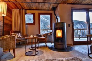 a living room with a fireplace in a house at Astraea in Peisey-Nancroix