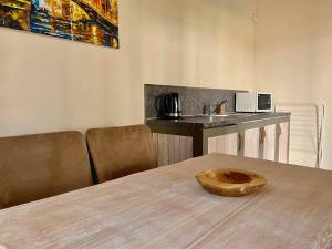 a room with a table with a wooden bowl on it at Gradina Forest Villas in Sozopol
