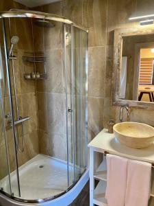 a bathroom with a shower and a sink at Gradina Forest Villas in Sozopol +13 photos