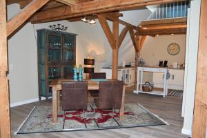 a dining room with a wooden table and chairs at Falkennest in Dhronecken