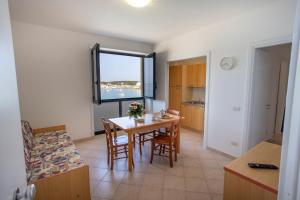 a kitchen and dining room with a table and chairs at Villa Altomare in Otranto