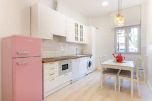 a kitchen with a pink refrigerator and a table at Old Town IV by Next Stop Bilbao in Bilbao