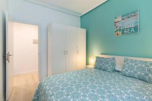 a blue bedroom with a bed and a white cabinet at Old Town IV by Next Stop Bilbao in Bilbao
