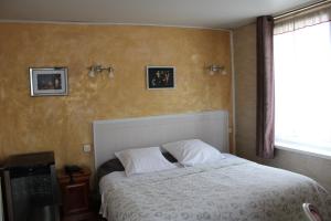 Postel nebo postele na pokoji v ubytování Hotel du Gambrinus