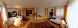 a large living room with a bed and a kitchen at Apartment Denk in Bregenz