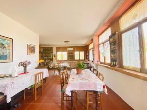 a dining room with two tables and chairs at Le Ginestre Alghero in Olmedo