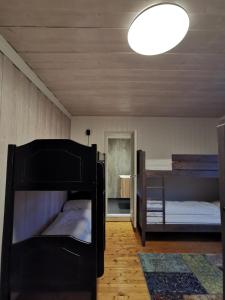 a bedroom with two bunk beds and a light at STORHAUGEN GARD in Lom
