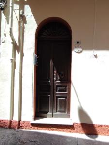 a black door in the side of a building at Casa Colombini in Iglesias