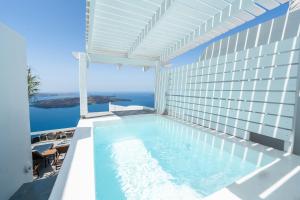 a swimming pool on the balcony of a building at Iatis View Collection in Imerovigli