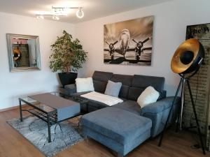 a living room with a couch and a table at Ferienwohnung Blümelring in Flatschach