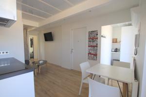 a kitchen and dining room with a table and chairs at La terrasse de Carras in Nice