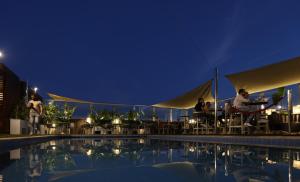 people sitting at tables by a pool at night at Le Palace d'Anfa in Casablanca