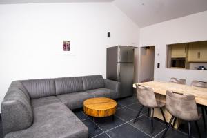 a living room with a couch and a table at Café Coureur Houffalize in Houffalize