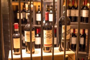 a bunch of bottles of wine sitting on a shelf at The Partridge, Stretton in Stretton