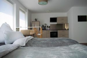 a bedroom with a large bed and a kitchen at unique flat in Düsseldorf